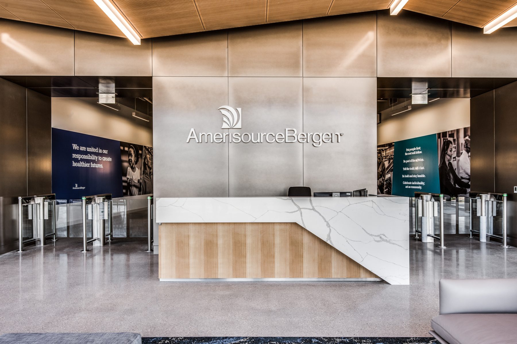 A corporate reception with a brushed metal AmerisourceBergen sign