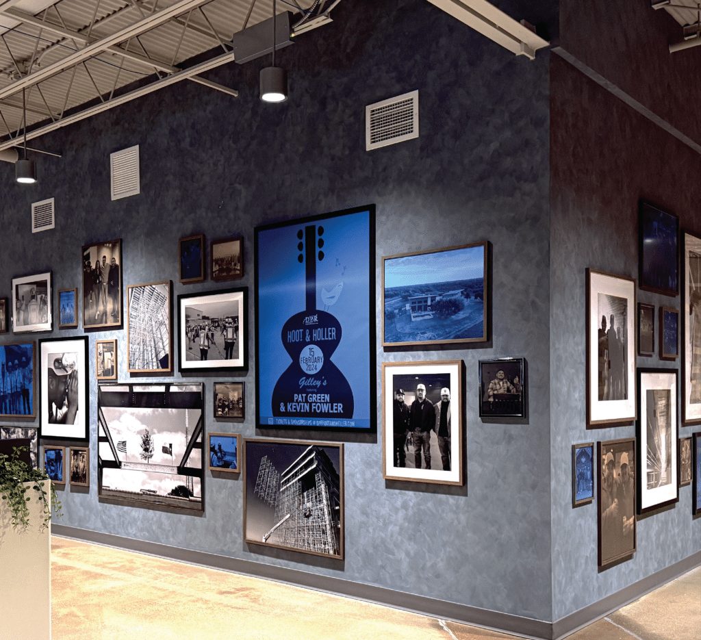 Gallery wall of framed black and white photographs and posters