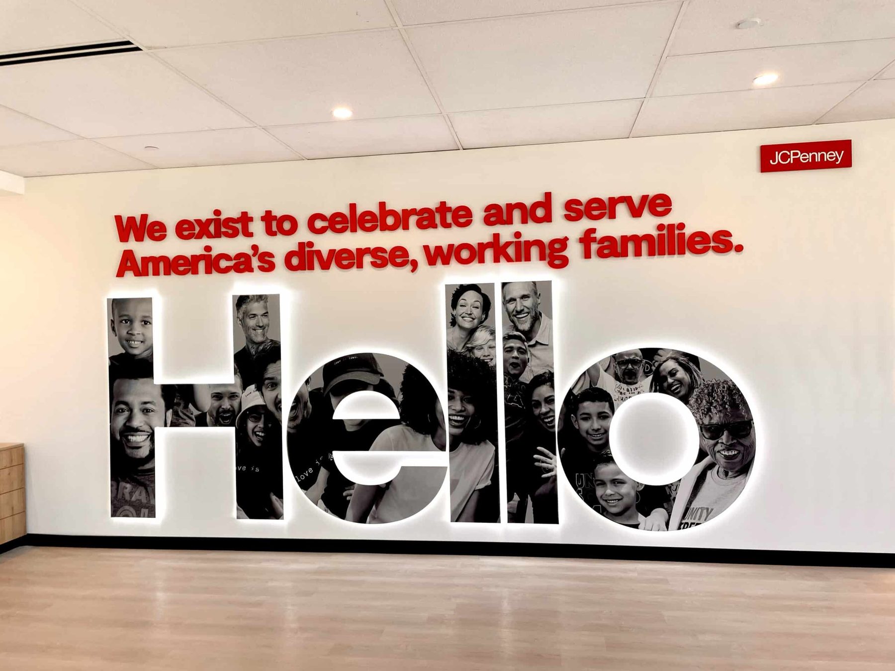 A dimensional Hello sign built from photographs on a corporate lobby wall