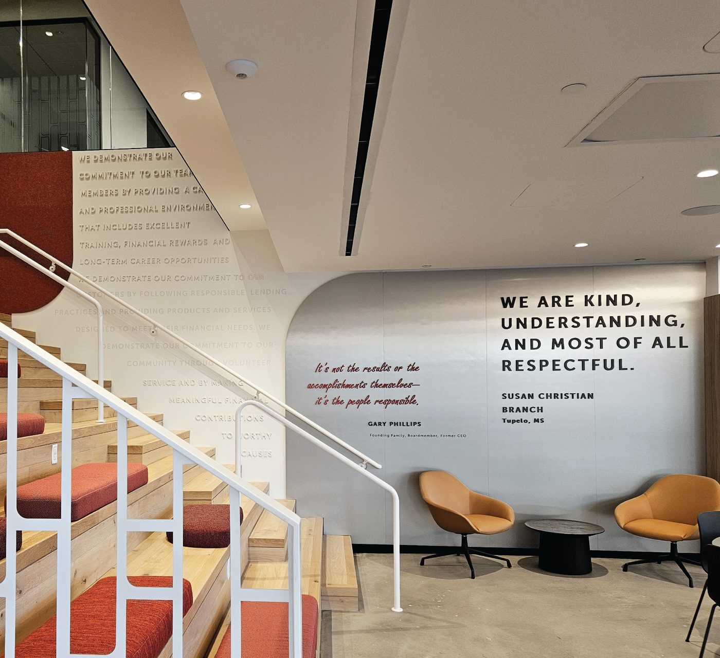 Staircase lobby with a curved wall of printed values statements