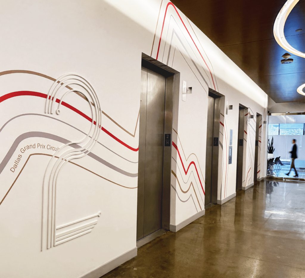 An elevator hallway wrapped in flowing line graphics